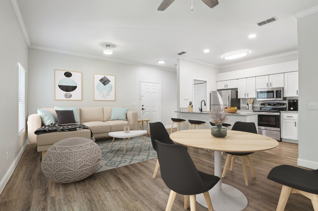 A modern living room with a round table and chairs.